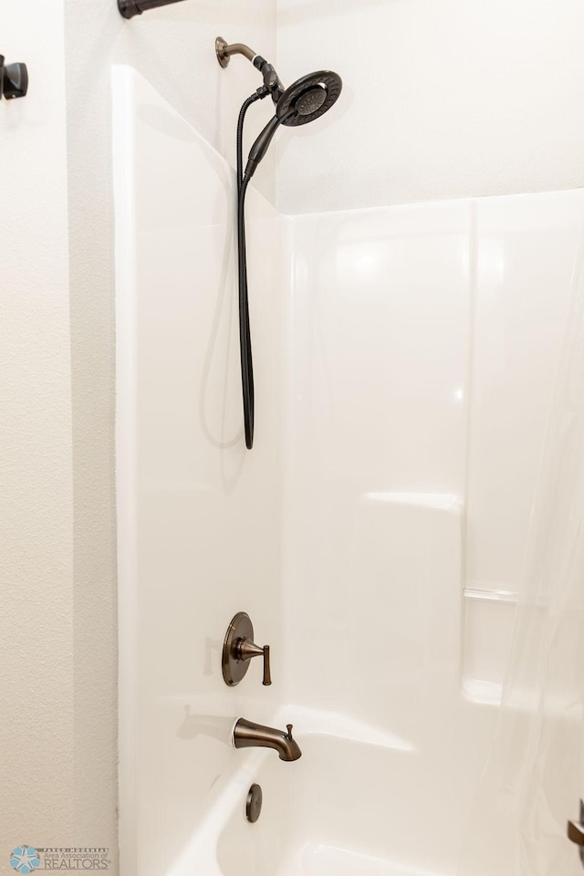 interior details with shower / bathtub combination