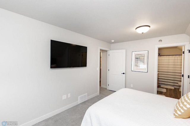 bedroom featuring baseboards, visible vents, and light carpet