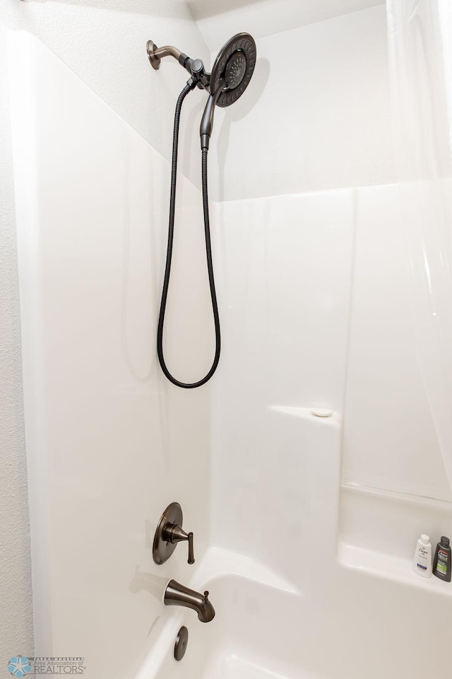 room details featuring bathing tub / shower combination