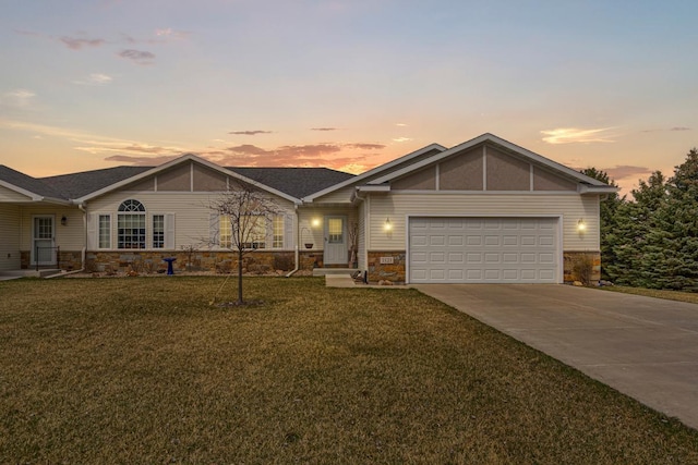 ranch-style home featuring an attached garage, stone siding, concrete driveway, and a lawn