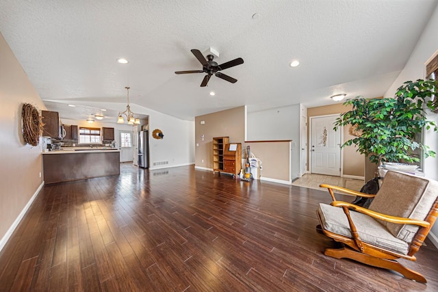 living room featuring dark wood-style flooring, a textured ceiling, ceiling fan, baseboards, and lofted ceiling