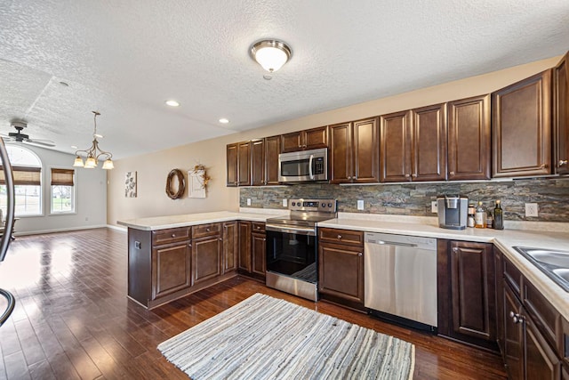 kitchen featuring backsplash, appliances with stainless steel finishes, a textured ceiling, and light countertops