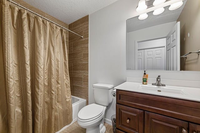 full bathroom featuring shower / bath combo with shower curtain, vanity, a textured ceiling, and toilet