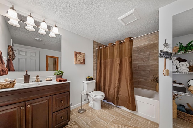 bathroom with visible vents, toilet, vanity, shower / bath combo with shower curtain, and a textured ceiling