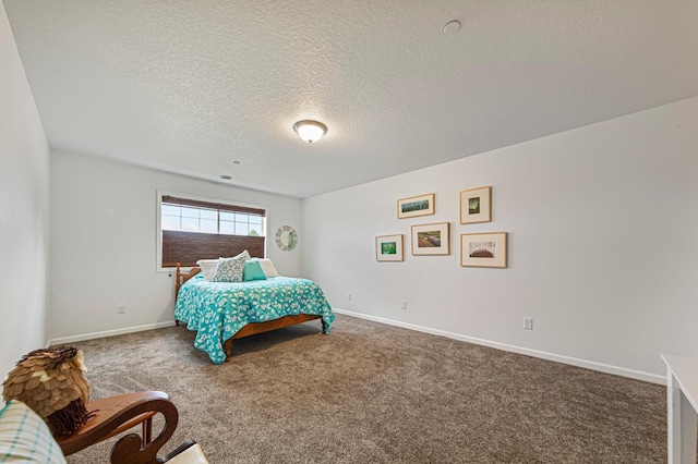 bedroom featuring carpet floors, a textured ceiling, and baseboards