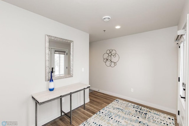 unfurnished bedroom featuring dark wood-style flooring, baseboards, and recessed lighting