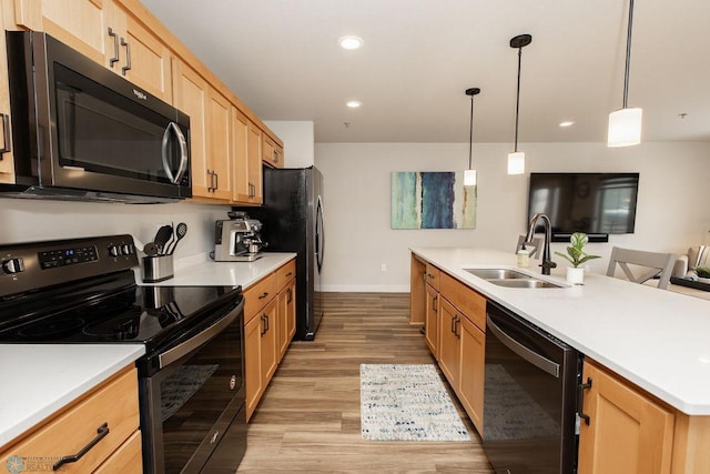 kitchen featuring electric range, a sink, baseboards, dishwashing machine, and light wood-style flooring