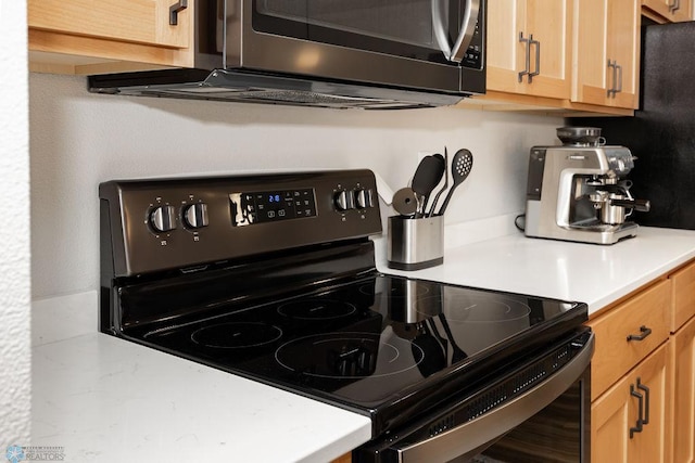 room details with light countertops and appliances with stainless steel finishes