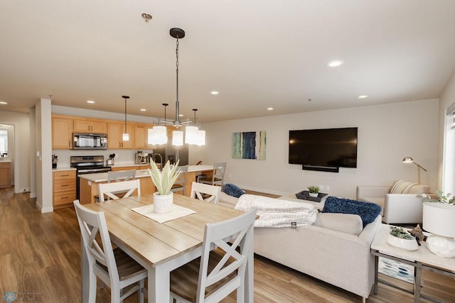 dining area featuring recessed lighting and wood finished floors