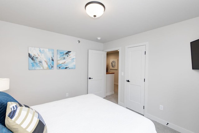 bedroom featuring baseboards and light colored carpet