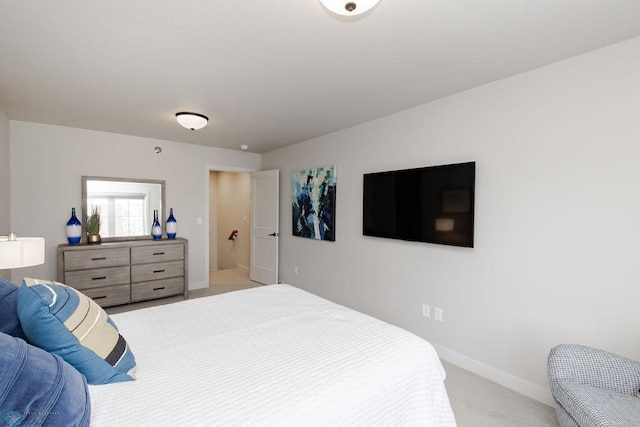 bedroom featuring baseboards and light colored carpet