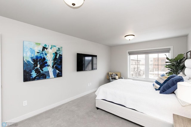 bedroom featuring baseboards and carpet