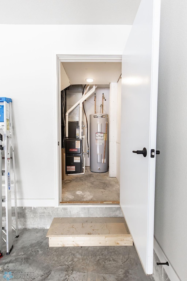 staircase with heating unit, concrete flooring, and electric water heater