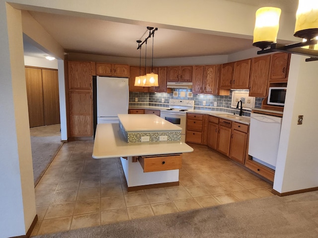 2155 6th Ln SE Unit 301, Cambridge, MN 55008 - kitchen with white appliances, under cabinet range hood, light countertops, decorative backsplash, and brown cabinets