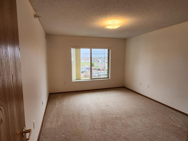 2155 6th Ln SE Unit 301, Cambridge, MN 55008 - carpeted spare room featuring a textured ceiling and baseboards