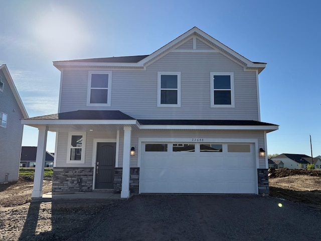 22648 Isla Way, Rogers, MN 55374 - view of front of property with a garage, a porch, stone siding, and driveway