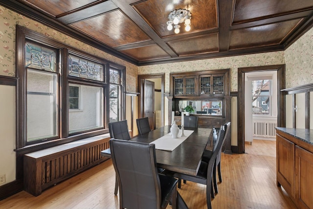 dining area featuring coffered ceiling, wallpapered walls, and light wood-style flooring