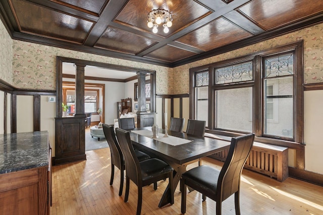 dining area with plenty of natural light, decorative columns, and wallpapered walls