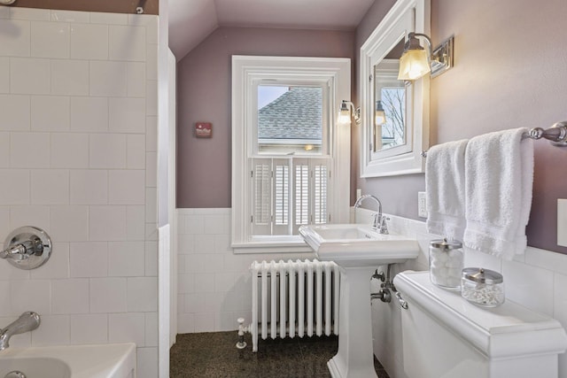 bathroom with shower / bathtub combination, lofted ceiling, toilet, tile walls, and radiator heating unit