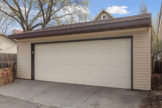 detached garage featuring fence