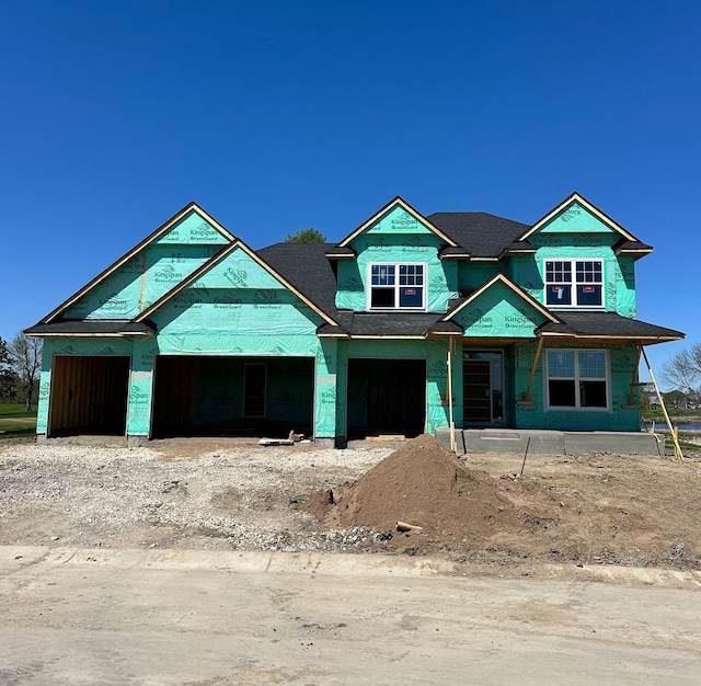 property under construction featuring a shingled roof