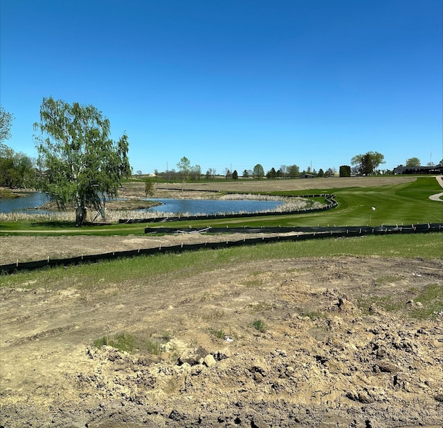 view of home's community with a water view and golf course view
