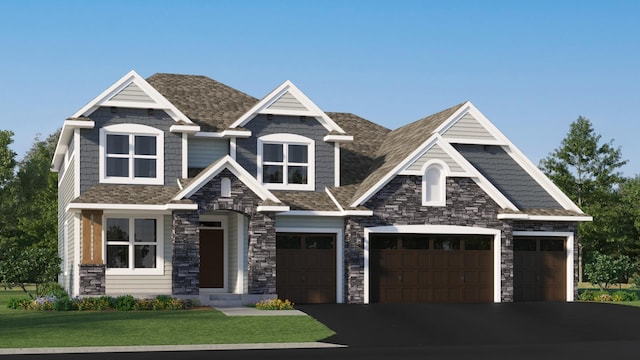 craftsman house with stone siding, asphalt driveway, a front yard, an attached garage, and roof with shingles
