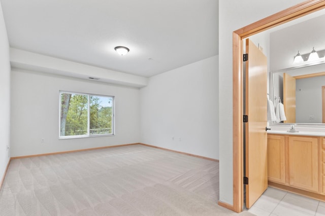 7100 Metro Blvd Unit 116, Edina, MN 55439 - unfurnished bedroom with baseboards, a sink, and light colored carpet
