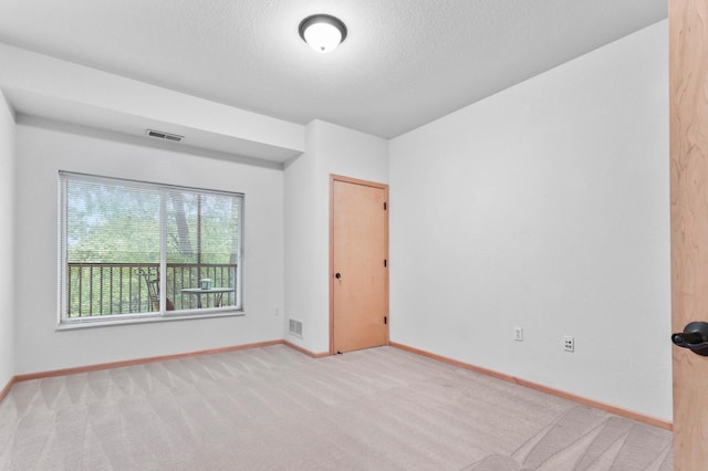7100 Metro Blvd Unit 116, Edina, MN 55439 - spare room featuring baseboards, carpet flooring, and a textured ceiling