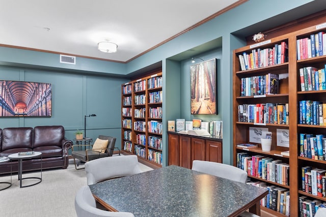 7100 Metro Blvd Unit 116, Edina, MN 55439 - living area featuring bookshelves, ornamental molding, built in shelves, and carpet flooring