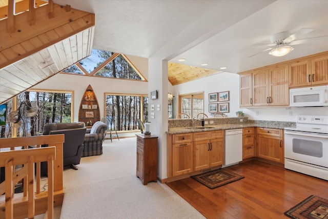 kitchen with white appliances, a sink, open floor plan, recessed lighting, and ceiling fan