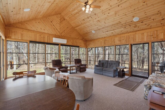 living room with a wall mounted air conditioner, high vaulted ceiling, ceiling fan, healthy amount of natural light, and carpet floors