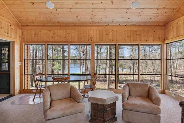 sunroom featuring vaulted ceiling and a water view
