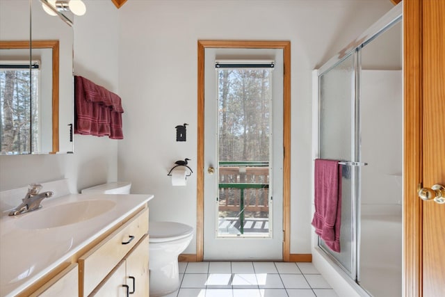 bathroom with vanity, a stall shower, tile patterned flooring, and toilet