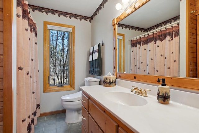 bathroom with tile patterned flooring, toilet, vanity, and baseboards