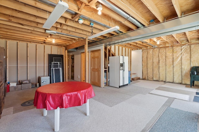 unfinished below grade area with white fridge with ice dispenser and billiards