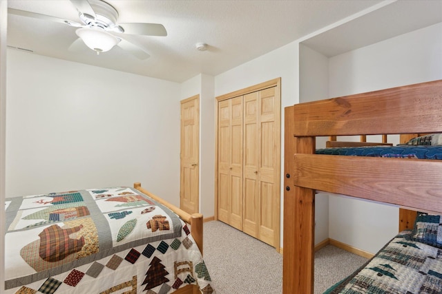 carpeted bedroom featuring ceiling fan and baseboards