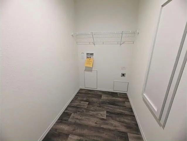 laundry room with washer hookup, electric dryer hookup, baseboards, dark wood-type flooring, and laundry area