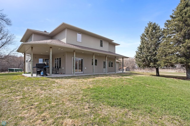back of house featuring a yard and a patio