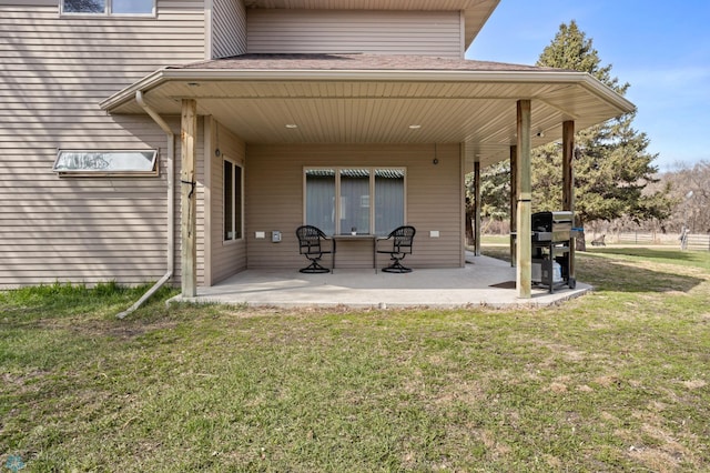 rear view of house with a lawn and a patio area