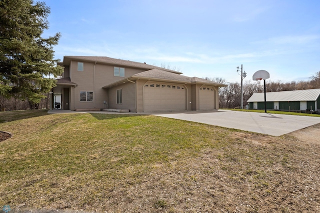 view of front of property with an attached garage, driveway, and a front yard