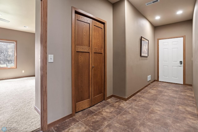 hall featuring recessed lighting, baseboards, and visible vents