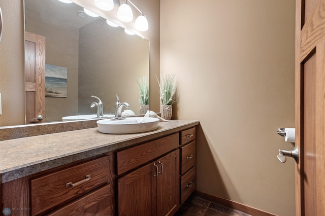 bathroom featuring vanity, tile patterned flooring, and baseboards