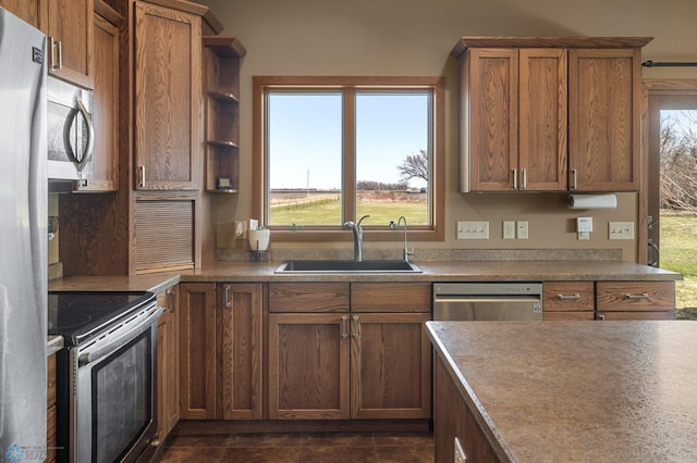 kitchen featuring a sink, open shelves, stainless steel appliances, and brown cabinets