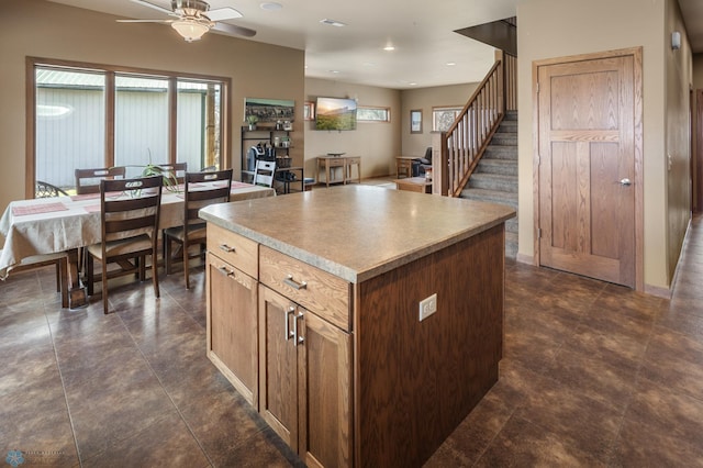 kitchen featuring a ceiling fan, recessed lighting, a healthy amount of sunlight, and a center island