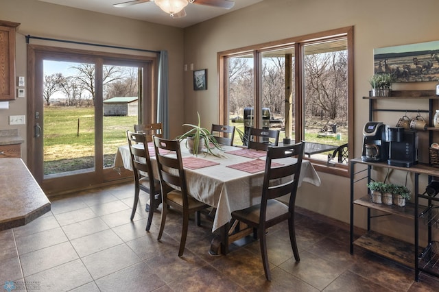 tiled dining room featuring a ceiling fan