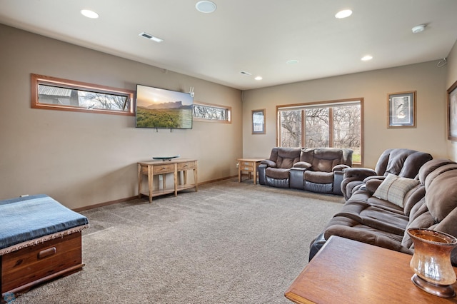 carpeted living area with baseboards, recessed lighting, and visible vents