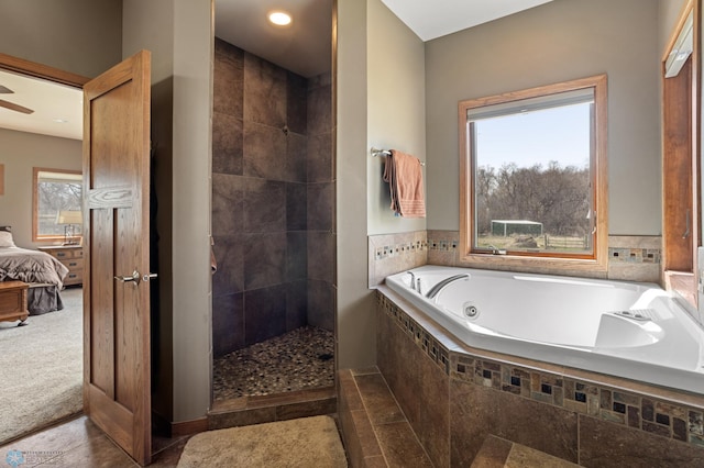 ensuite bathroom with walk in shower, ensuite bath, a whirlpool tub, a ceiling fan, and baseboards