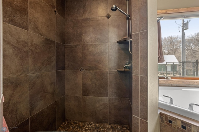 bathroom with a tile shower and a wealth of natural light