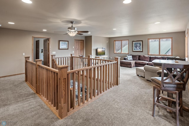 carpeted living area with recessed lighting, baseboards, and ceiling fan
